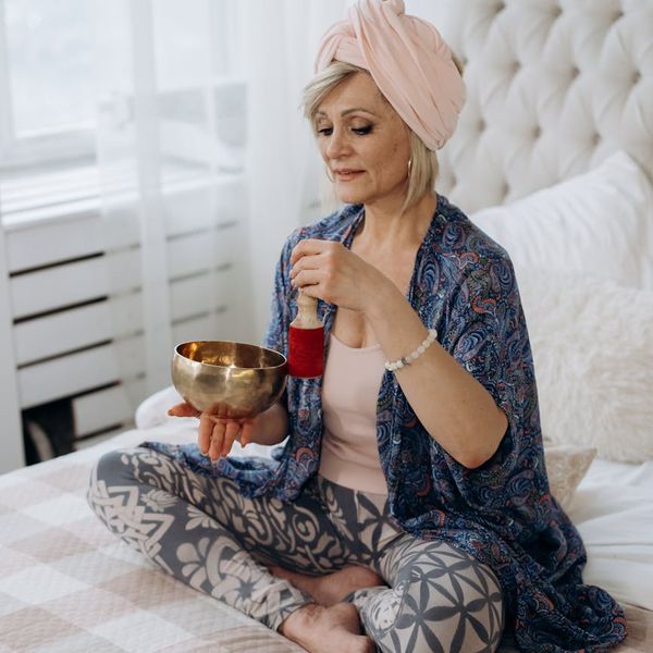 Person meditating peacefully, radiating an aura of calm energy.